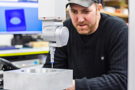 A CMM machine is being used to validate an internal surface profile on this aluminum machined part