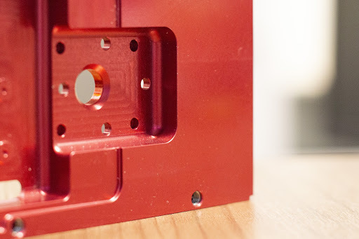 This aluminum CNC machined part required color anodize as well as installed helical inserts