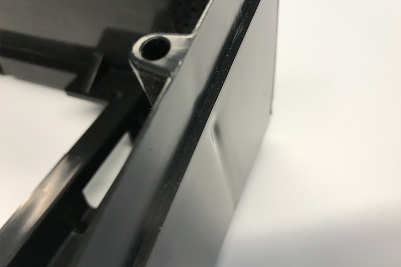 A part with thick features on the opposite side of a face, which can cause sink